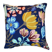 Floral-patterned pillow with colorful flowers on a blue background