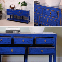 Collage of blue console table with gold accents in various settings.