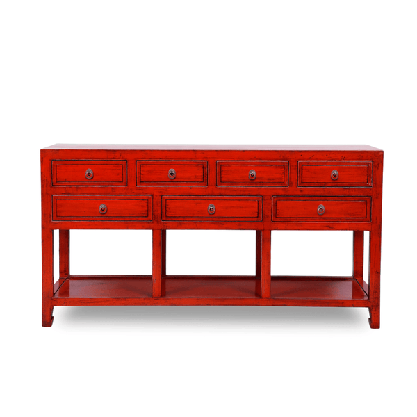 Red console table with multiple drawers on a white background