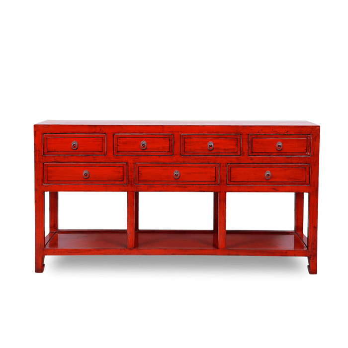 Red console table with multiple drawers on a white background