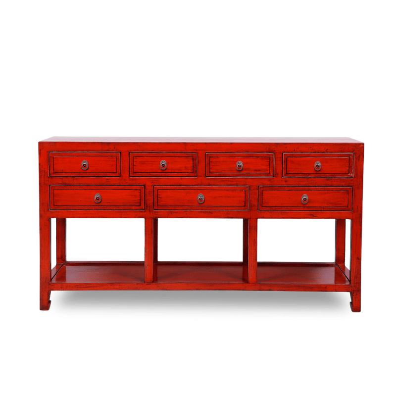 Red console table with multiple drawers on a white background