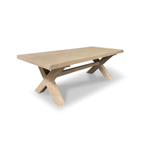 Wooden dining table with X-shaped legs on a white background