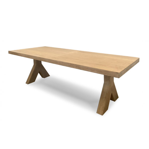 Wooden dining table with X-shaped legs on a white background