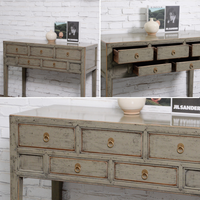Collage of a wooden console table with multiple drawers against a white brick wall.
