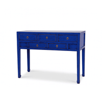 Blue console table with multiple drawers on a white background