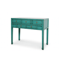 Teal console table with multiple drawers on a white background