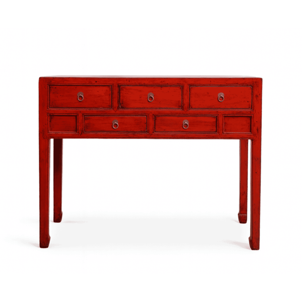 Red console table with multiple drawers on a white background