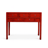Red console table with multiple drawers on a white background