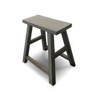 Wooden stool with a grayish-brown top and black legs on a white background